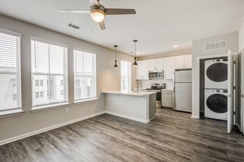 A kitchen and living room with a washer and dryer